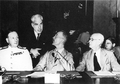Delegates confer during a meeting recess