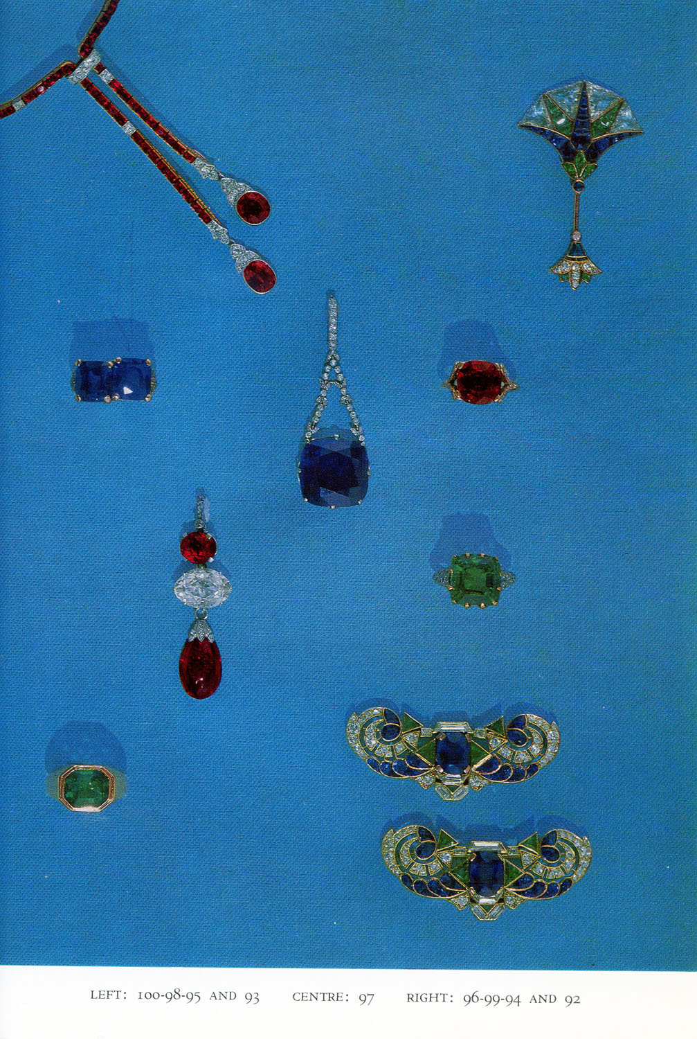 Jewelry, Including 24.9 carat sapphire and diamond pendant (97, center), 9 carat emerald and diamond ring (94, right, lower middle), and diamond and sapphire broochs (92, lower right).
