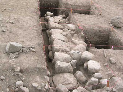 Fig. 4: The eastern, north–south trending Inca wall (Fea 1) on north side of semi-subterranean temple exposed during test excavations in 2008 corresponding to one of anomalies identified through remote-sensing, looking north. Wall is 1.2m thick with roughly finished stones comprising exterior faces on either side and interior rubble fill.