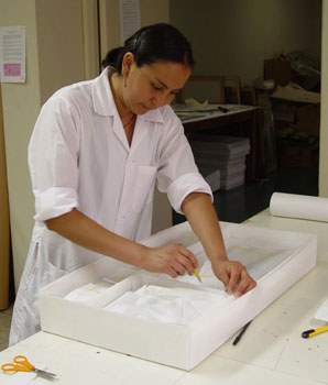 Haydée Grandez adjusts the internal divisions of a storage box that she constructed and worked with her colleagues to design.