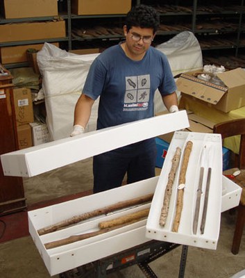 Ivan Ccachura demonstrates one of the storage boxes he designed to house staffs of different lengths from the Paracas site.