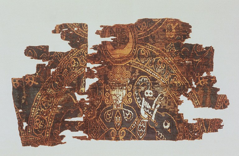 Fragments of a textile depicting an individual holding the trunks of an elephant in either hand