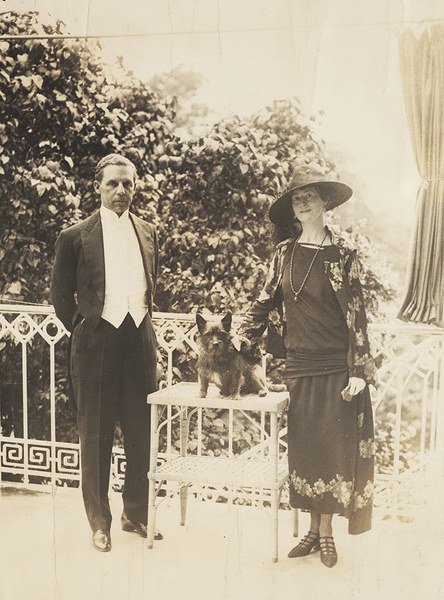 Mildred and Robert Woods Bliss standing, with a dog on a table between them