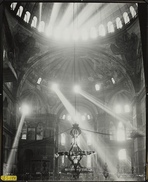 Hagia Sophia, with rays of light coming in from windows and a chandelier in the foreground