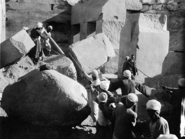 Local workmen moving a stone block 