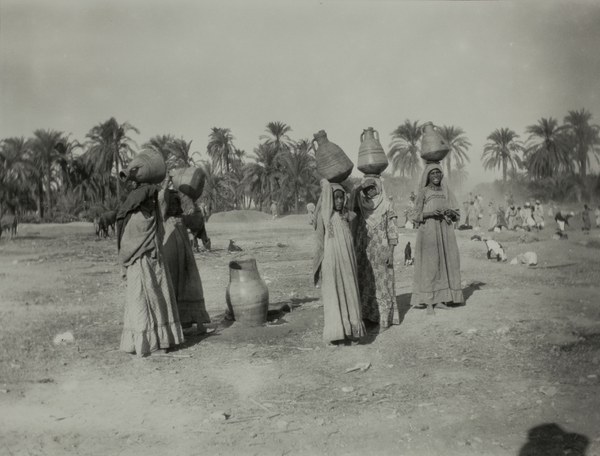 Women carrying ceramic jugs over their heads