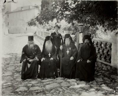 Four seated monks, Thomas Whittemore (left), and George D. Pratt (right)