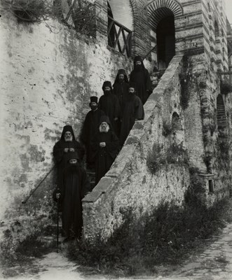 Monks and the Abbot standing on the exterior stairway