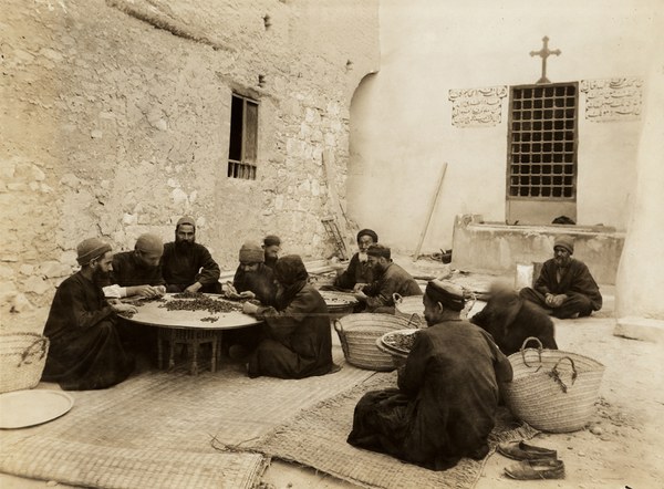 Monks sorting dried grapes
