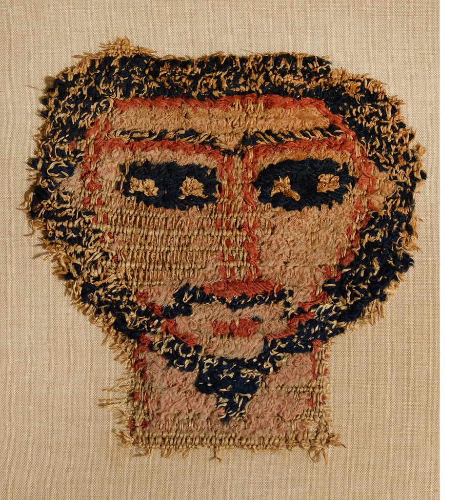 Fragment of a hanging depicting the bearded face of a human figure