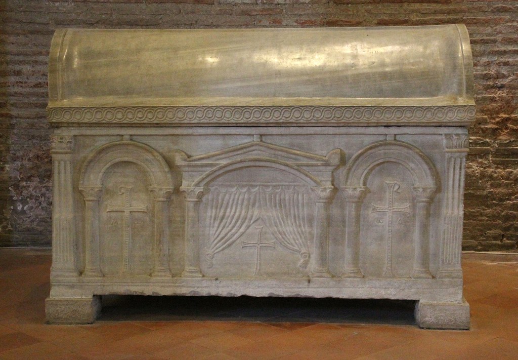 Marble sarcophagus relief: the cross revealed between curtains