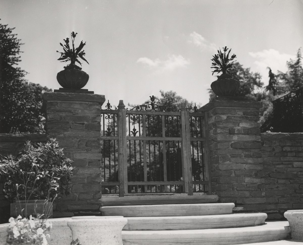 Ironwork bouquets atop stone pillars and gate from Arbor to Fountain Terrace