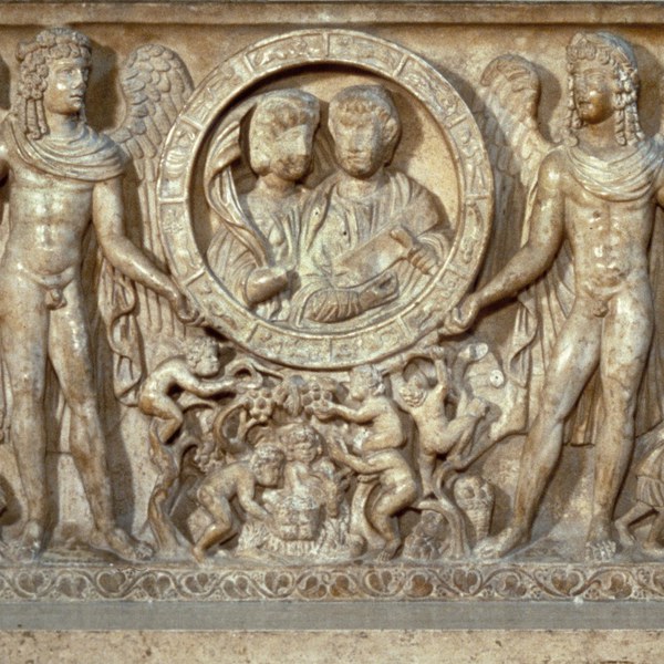 Section of carved marble depicting bust length figures of a couple within a zodiac ring, flanked by two winged youths