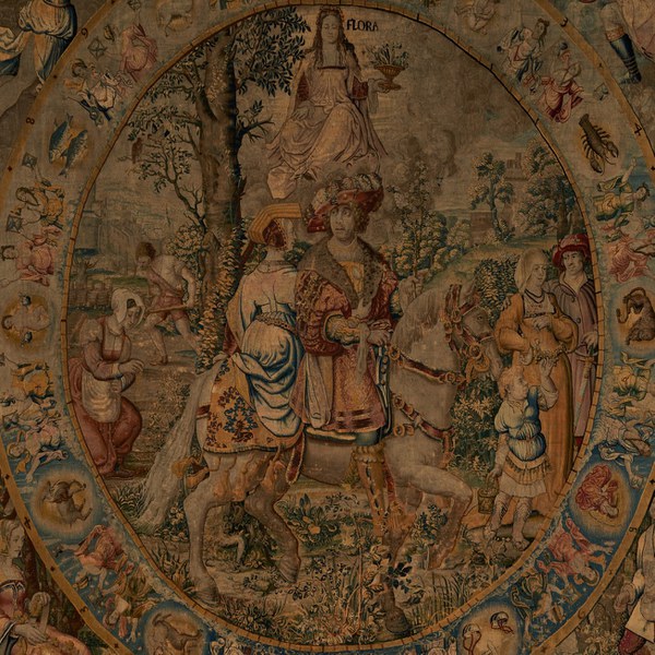 Tapestry depicting the goddess of flowers overseeing an aristocratic couple riding through the countryside where peasants sow grain and till the fields and a couple and child stroll. 